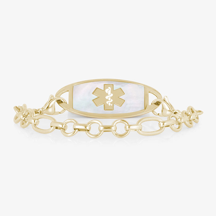 Gold-tone medical ID bracelet with a white inlay tag, medical symbol, and alternating round and oval links.