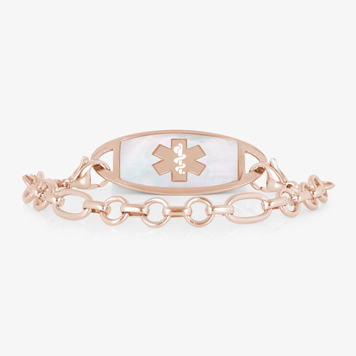 Rose gold-tone medical ID bracelet with a white inlay tag, medical symbol, and alternating round and oval links.