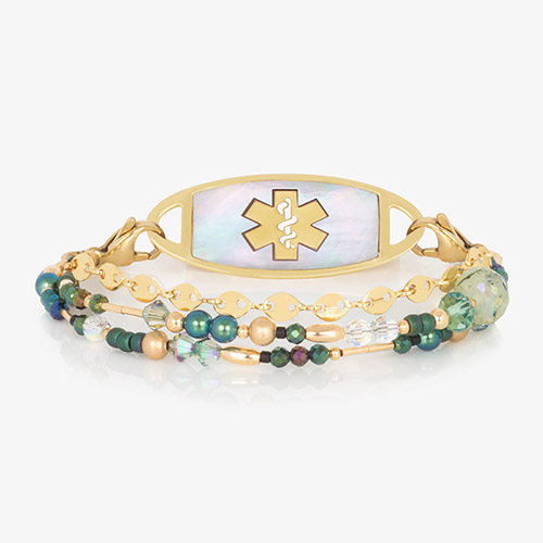 Gold and green beaded multi-strand and chain medical ID bracelet paired with gold tone stainless steel medical ID tag with mother of pearl inlay and gold tone medical symbol at the center.