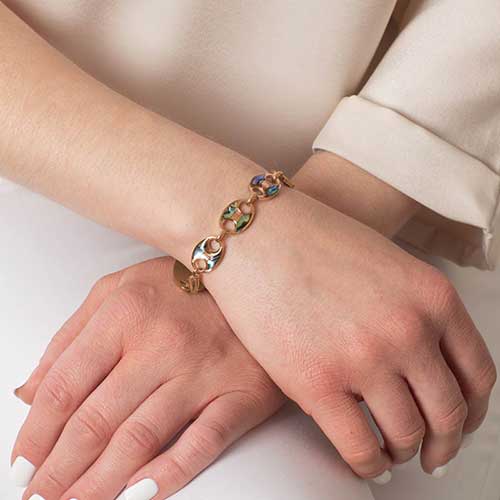 Abalone inlay rose gold medical ID bracelet worn on wrist, featuring mariner-style links and secure clasp