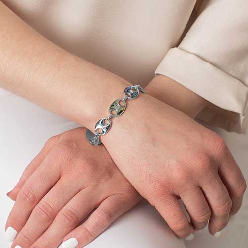 Abalone inlay stainless steel medical ID bracelet worn on wrist, with mariner-style links for a bold, elegant look