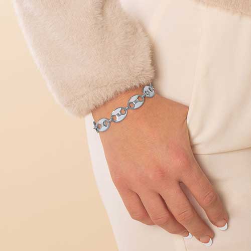 Woman wearing stainless steel mariner link medical ID bracelet with mother of pearl inlay.