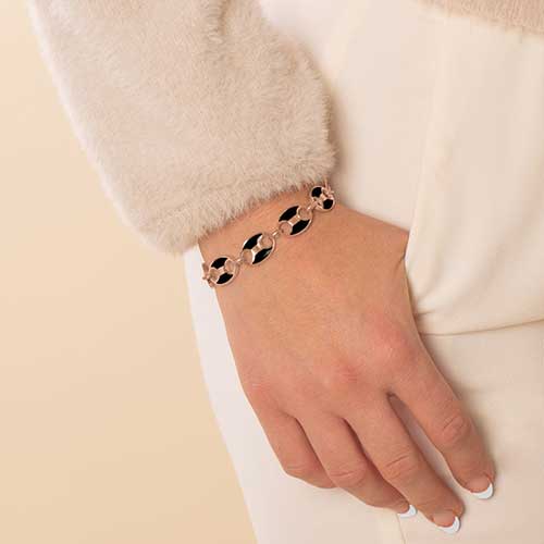 Woman wearing rose gold tone stainless steel mariner link medical ID bracelet with black paint inlay.