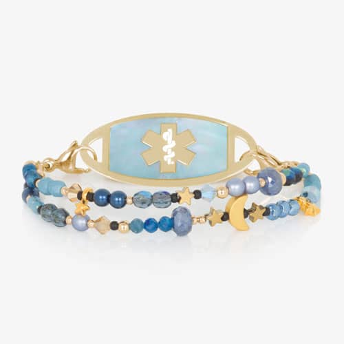 Gold-tone medical ID bracelet with a blue mother-of-pearl emblem plate, blue gemstone beads, and celestial moon and star accents.