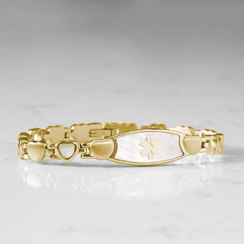 Feminine yellow gold plated linked bracelet with mother of pearl medical ID tag and yellow gold medical caduceus symbol