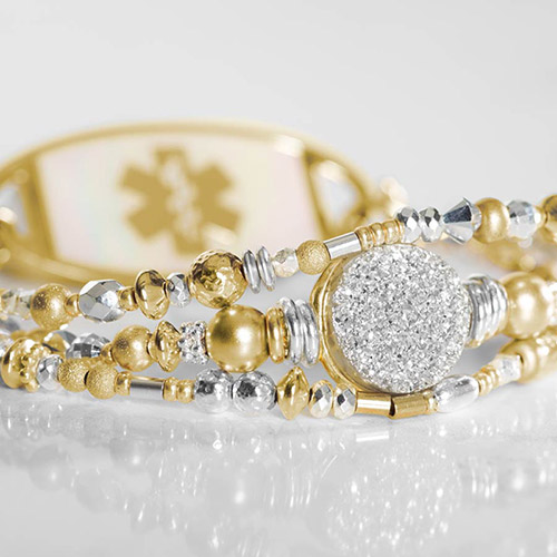 Alternate flat lay of silver and gold beaded medical ID bracelet with lobster clasp and engraved ID tag.