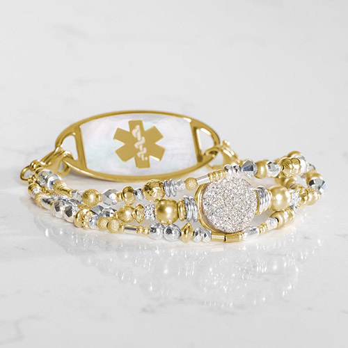 Two-strand beaded medical ID bracelet in silver and gold tones, displayed flat with engraved tag showing.