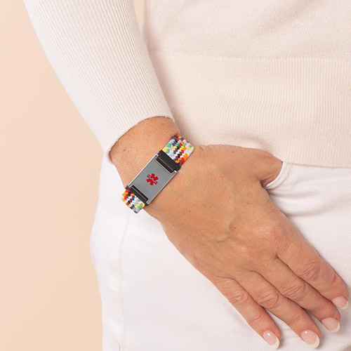 Urban Stretch Medical Alert Bracelet in Rainbow and Silver, shown on wrist for daily wear, featuring a bold red medical caduceus symbol