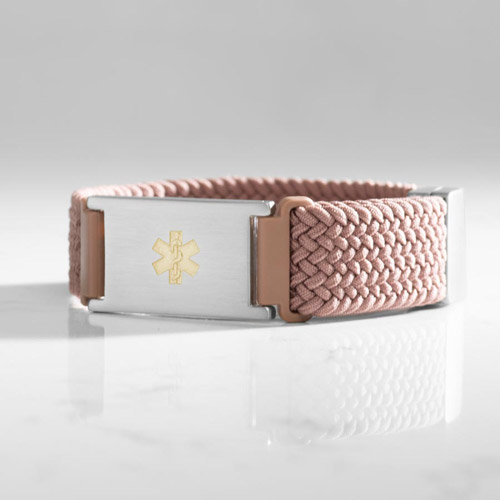 Urban Stretch Medical ID Bracelet in Rosewood and Silver with woven and braided stretch band, featuring a gold medical caduceus symbol on a marble counter
