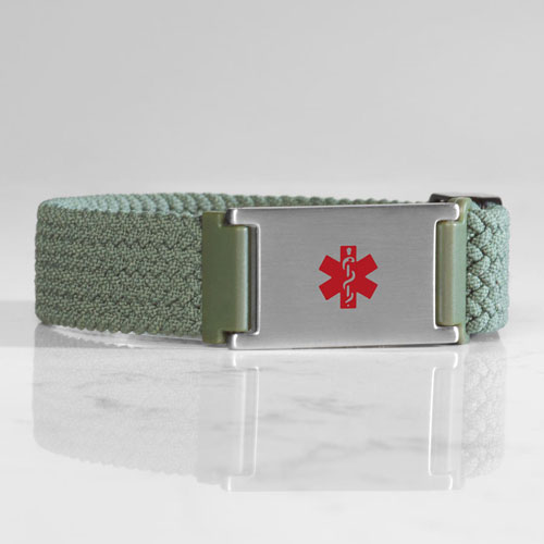 Urban Stretch Magnetic medical ID bracelet with red medical caduceus on marble background