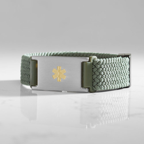 Urban Stretch Magnetic medical ID bracelet with gold medical caduceus on marble background