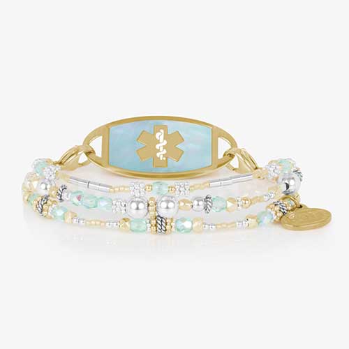 Close-up of the Rhythm &amp; Blues in Gold medical ID bracelet on a black background, showcasing its polished gold and blue beadwork.