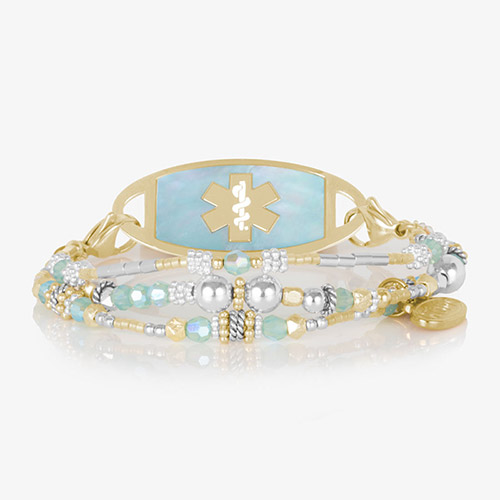 Close-up of the Rhythm &amp; Blues in Gold medical ID bracelet on a black background, showcasing its polished gold and blue beadwork.