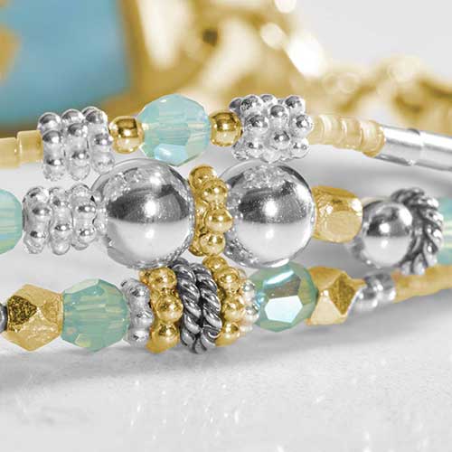 Angled layflat of the Rhythm & Blues in Gold bracelet with the medical ID tag facing up, emphasizing the engraved red medical symbol.