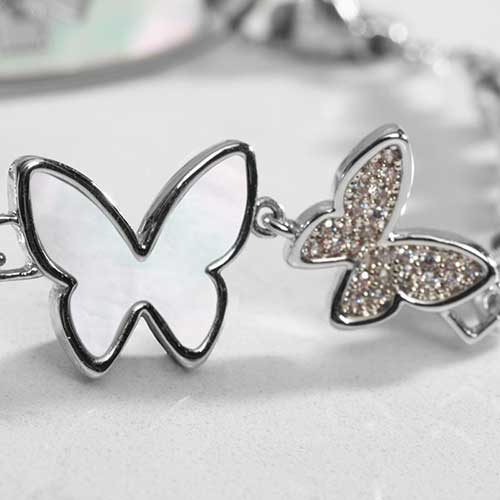 Close up of double butterfly centerpiece with crystals and mother of pearl inlay.
