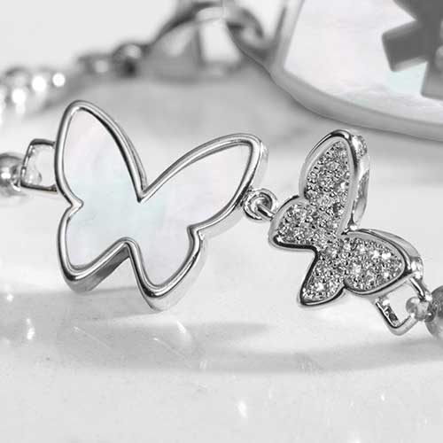 Close up of double butterfly centerpiece with crystals and mother of pearl inlay.