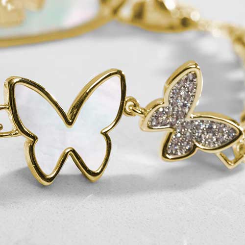 Close up of double butterfly centerpiece featuring inlaid mother of pearl and crystal adornments.