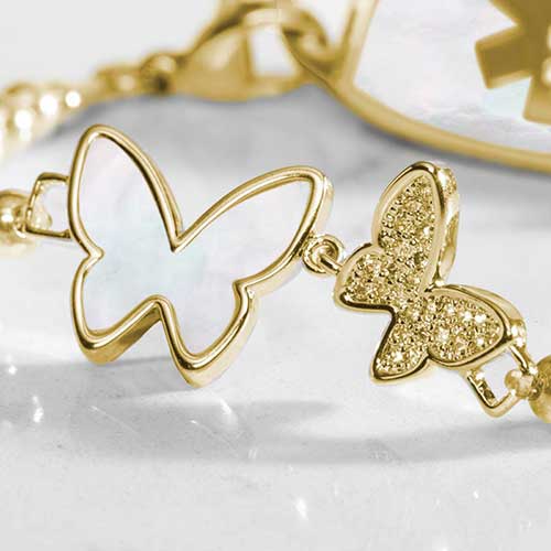 Close up of double butterfly centerpiece featuring inlaid mother of pearl and crystal adornments.