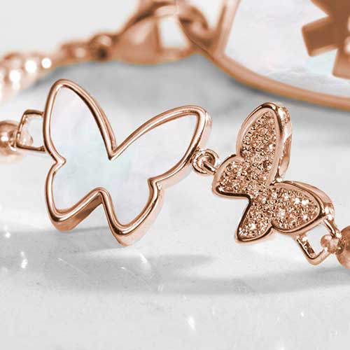 Close up of a double butterfly centerpiece adorned with crystal and mother of pearl inlay.