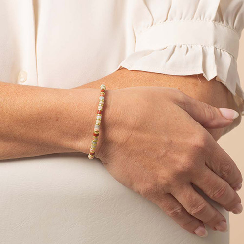 Close-up of the Aris medical ID bracelet from Lauren’s Hope, featuring multicolor heishi beads in soft earth tones with a lightweight stretch design.