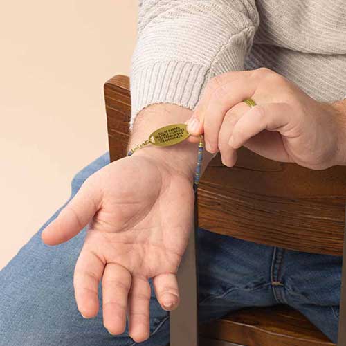 Man showing the custom laser engraving on his medical ID.