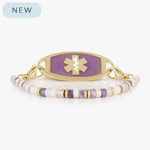 Beaded bracelet featuring gold tone, howlite, and Amethyst beads on a stretch bracelet, attached to a gold tone medical ID with Amethyst inlay and gold tone caduceus medical symbol.