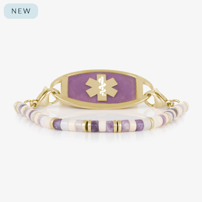 Beaded bracelet featuring gold tone, howlite, and Amethyst beads on a stretch bracelet, attached to a gold tone medical ID with Amethyst inlay and gold tone caduceus medical symbol.