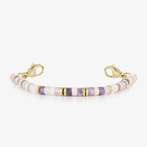 Beaded bracelet featuring gold tone, howlite, and Amethyst beads on a stretch bracelet.