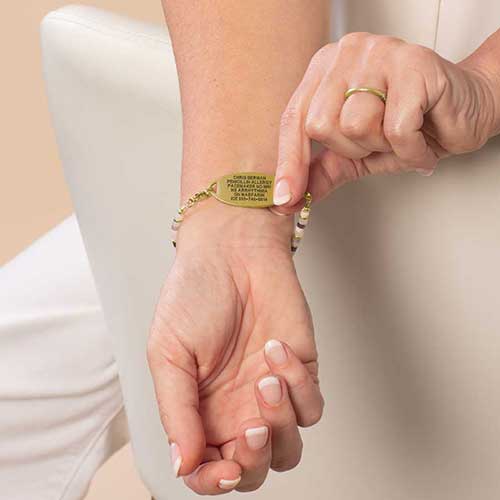 Woman display the custom, laser engraving on her medical ID.