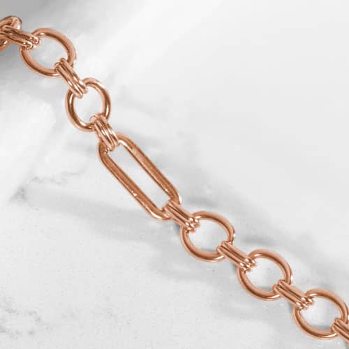 Classic rose tone chain in alternating link sizes and shapes which attaches to a tag using the 2 lobster clasps.