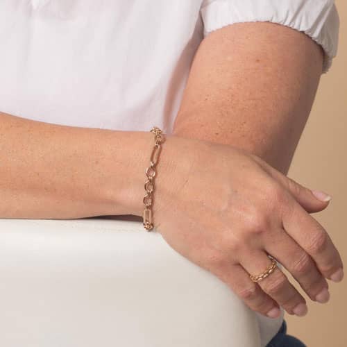 Women displaying a Classic rose tone chain in alternating link sizes and shapes which attaches to a medical ID tag using the 2 lobster clasps.