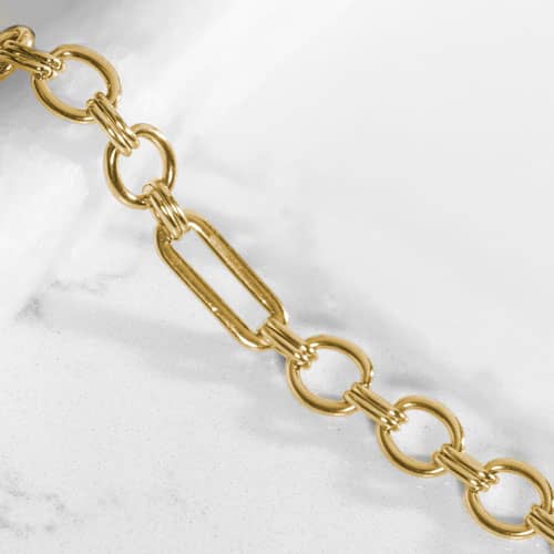 Classic Gold tone chain in alternating link sizes and shapes which attaches to a tag using the 2 lobster clasps.