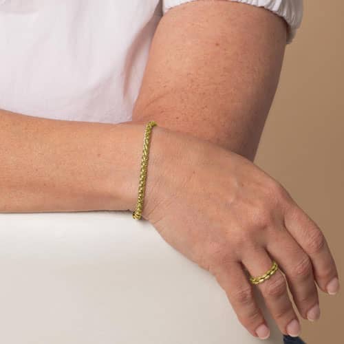 Gold-tone wheat chain medical ID bracelet worn on the wrist.