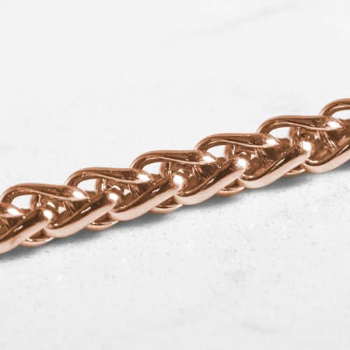 Close-up of the polished rose gold wheat chain links.