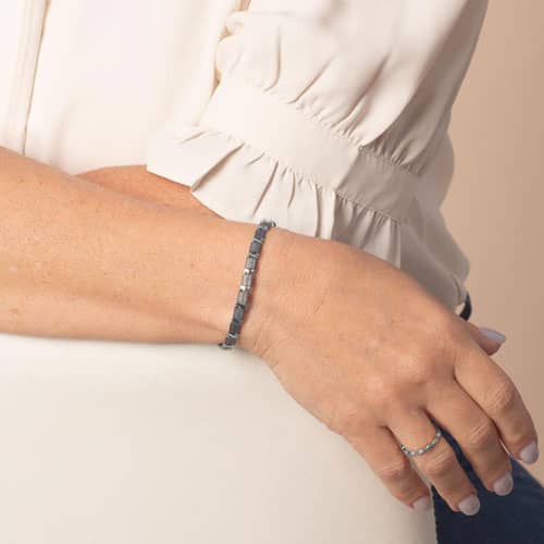 Slate blue tiled bracelet with silver-tone accents worn on the wrist.