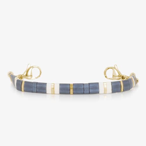 Gold-tone bracelet with blue and white tile beads, gold accents, and lobster clasp closures.