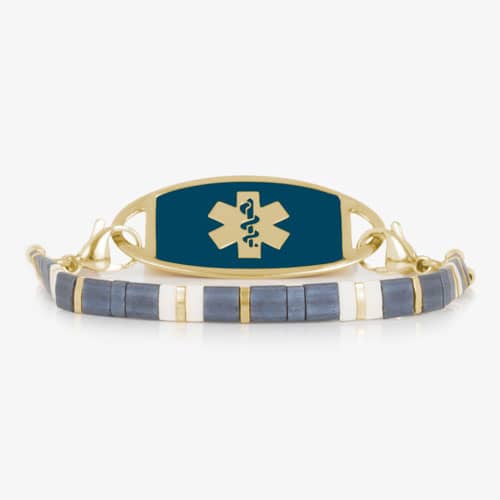 Gold-tone medical ID bracelet with a deep blue sapphire-colored tag and Star of Life, paired with blue, white, and gold tile beads.