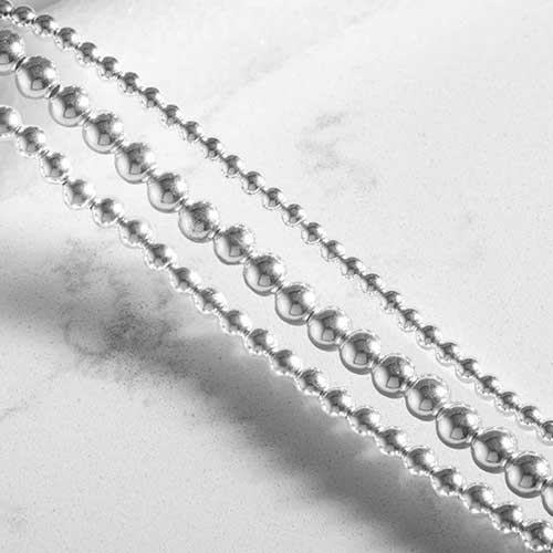 Close-up of the Tilly bracelet’s three strands of polished silver beads.