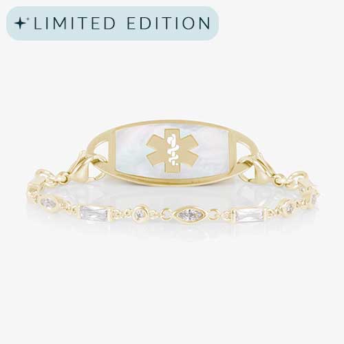 12 karat gold plated med ID tennis bracelet with round, oval, and rectangle clear cubic zirconia crystals and decorative med ID tag.