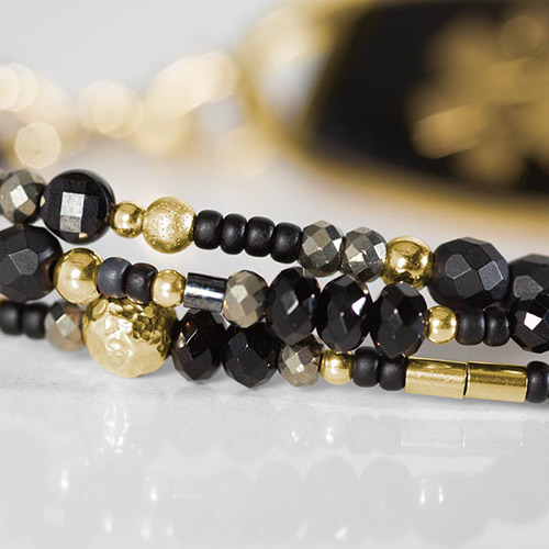 Close-up of bracelet details on Cher Medical Alert Bracelet, showcasing matte black agate, black spinel, and tourmaline with gold-filled beads