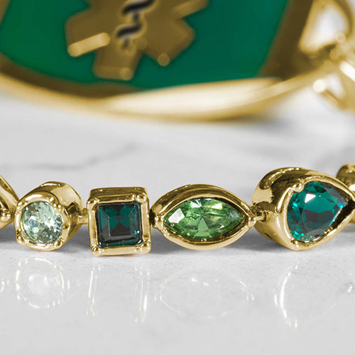 Close-up of Kate Medical Alert Bracelet in Emerald and 12k Gold Plate, with a mix of cubic zirconia crystals in luxe bezels, ideal for interchangeable medical ID tags
