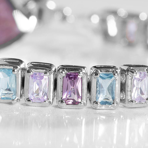 Close-up of bracelet details on Monica Medical ID Bracelet, highlighting lavender, amethyst, and aquamarine stones in silver-tone bezels