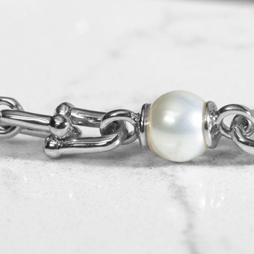 Close up of Bridle links in silver paired with luminous faux pearls