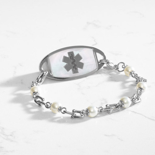 Bridle links in silver paired with luminous faux pearls and attached to a silver medical ID tag with inlaid mother of pearl.