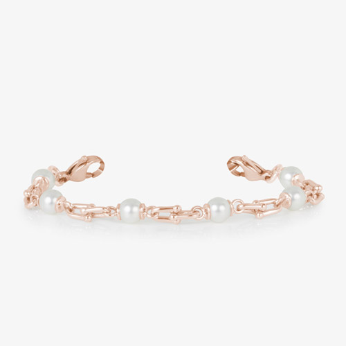 Bridle links in rose gold paired with luminous faux pearls.