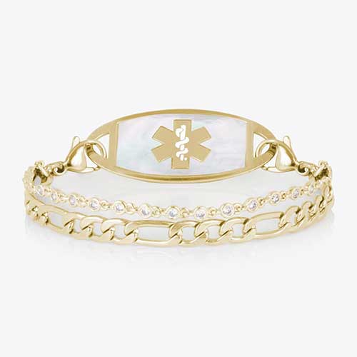 Gold toned two strand bracelet featuring a classic figaro chain, and a dainty, round CZ chain. All attached to a silver medical ID tag featuring inlaid Mother of Pearl and a gold caduceus.