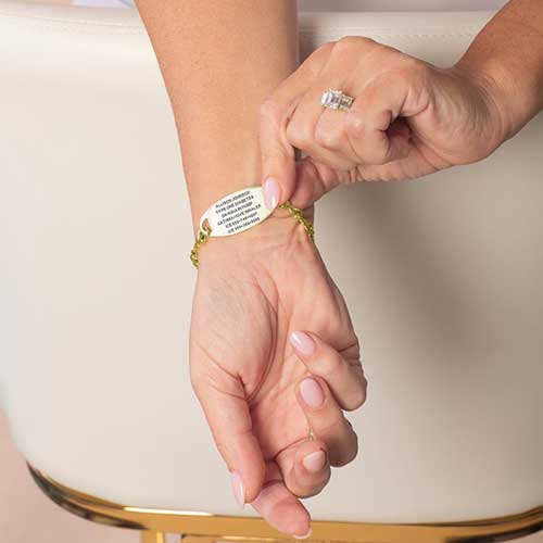 Woman displaying the custom, laser engraved, medical information on her ID tag.