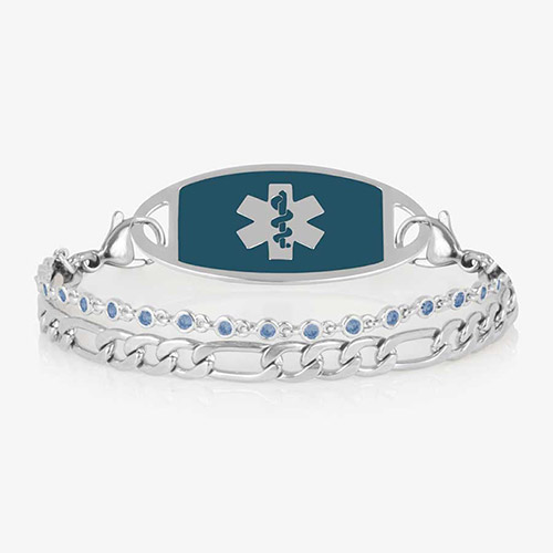 Women's silver medical alert bracelet featuring sapphire-blue emblem tag and light blue crystal accents, combining beauty with lifesaving information.