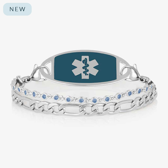 Women's silver medical alert bracelet featuring sapphire-blue emblem tag and light blue crystal accents, combining beauty with lifesaving information.