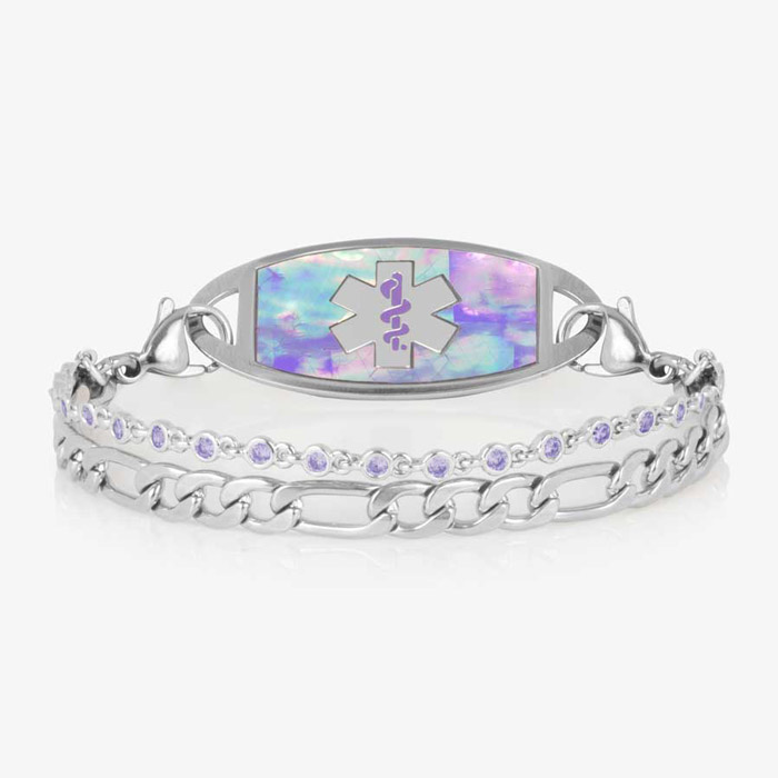 Women's medical ID bracelet with iridescent lavender opal inlay tag and light purple crystal accents on a double silver chain, engraved with the medical alert symbol.